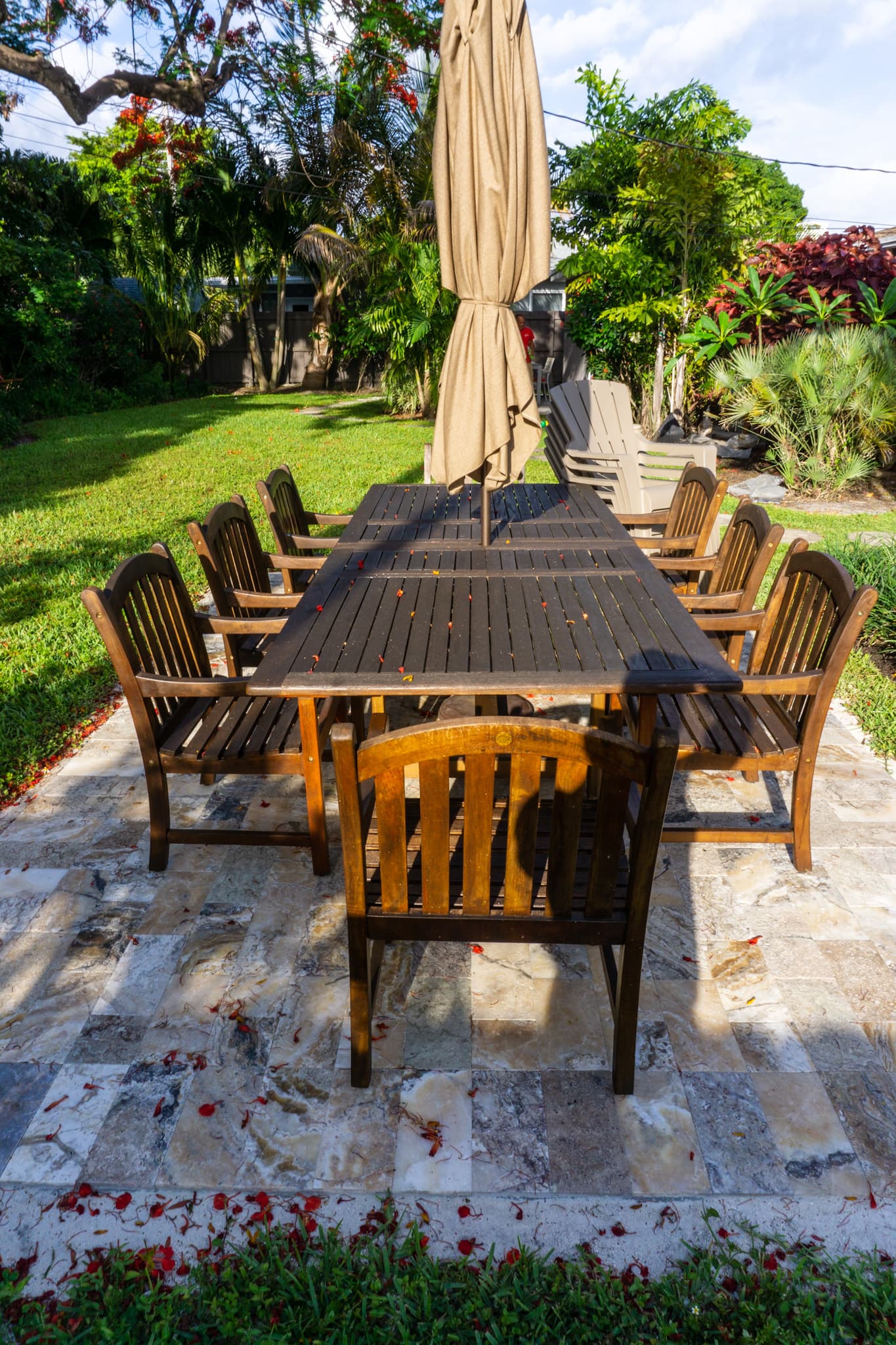 Outdoor dining table surrounded by tropical gardens at Solstice at Wilton